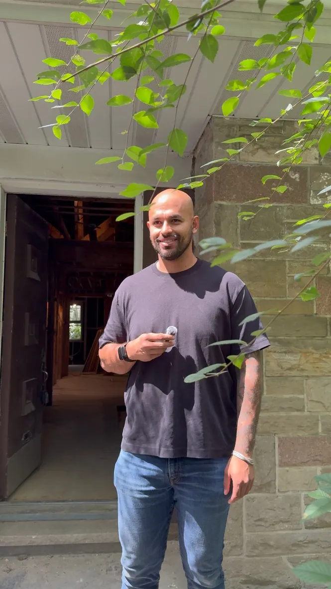 Samuel Perez at the entrance of a home under renovation